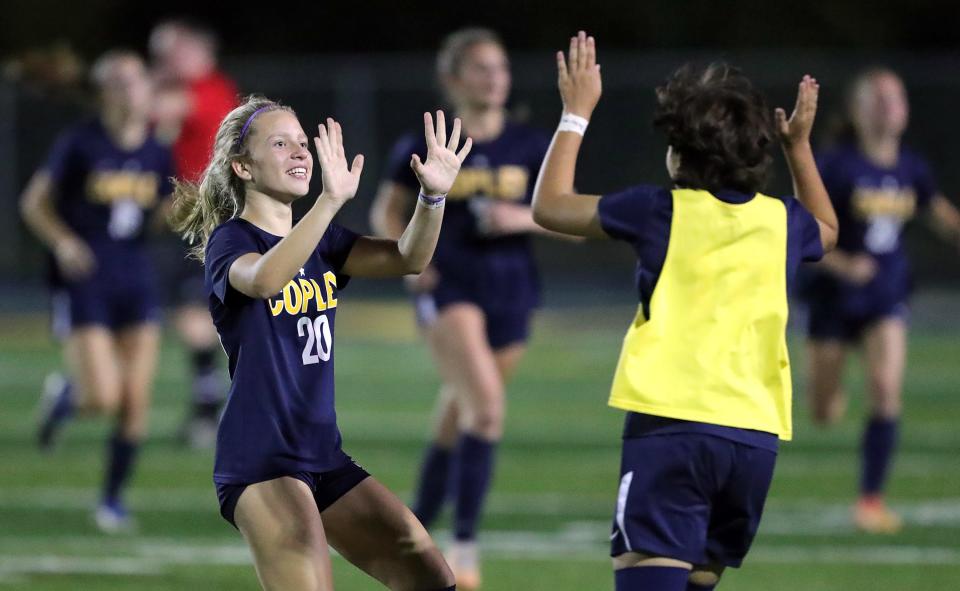 Copley's Sophie Arnold, left, celebrates with teammates after beating Revere on Wednesday in Copley.