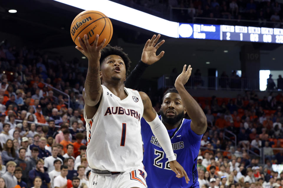 Auburn guard Wendell Green Jr. (1) shoots as Saint Louis forward Terrence Hargrove Jr. (22) defends during the second half of an NCAA college basketball game Sunday, Nov. 27, 2022, in Auburn, Ala. (AP Photo/Butch Dill)