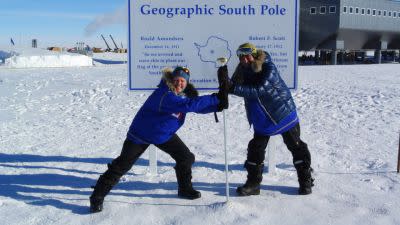 Members of the Test Your Limits team fight over the South Pole marker.