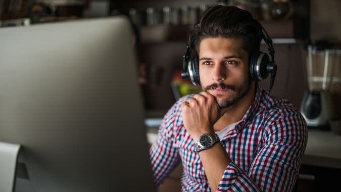 man listening to the music while working on a computer.