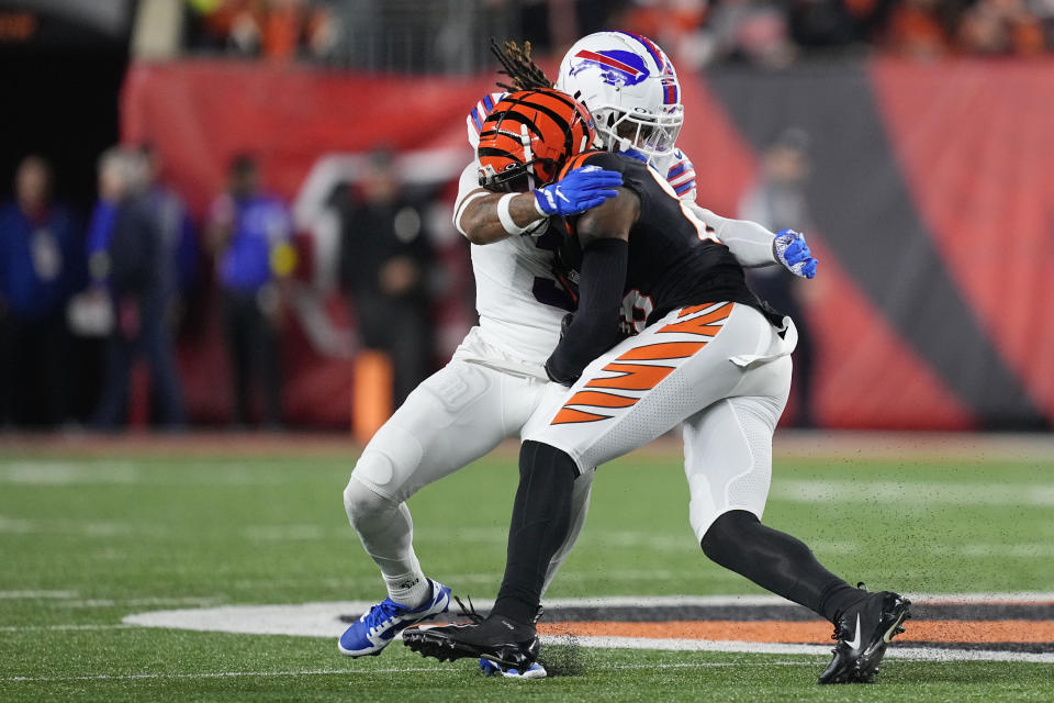 Damar Hamlin of the Buffalo Bills tackles Tee Higgins of the Cincinnati Bengals.