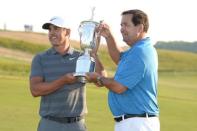 Jun 17, 2018; Southampton, NY, USA; Brooks Koepka holds the trophy with his father Bob Koepka after winning in the final round of the U.S. Open golf tournament at Shinnecock Hills GC - Shinnecock Hills Golf C. Dennis Schneidler-USA TODAY Sports