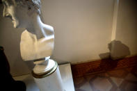 The 'Bust of Leopoldo Cicognara' by Antonio Canova casts its shadow against a wall showing a dark stain indicating the level the water reached during the latest high tide flooding, at the Accademia Gallery, in Venice, Saturday, Nov. 16, 2019. As high tidal waters returned to Venice on Saturday, four days after the city experienced its worst flooding in 50 years, young Venetians are responding to the worst flood in their lifetimes by volunteering to help salvage manuscripts, clear out waterlogged books and lend a hand where needed throughout the stricken city. (AP Photo/Luca Bruno)