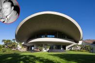 <b>Bob and Dolores Hope's Estate</b><br> <b>Palm Springs, California </b><br> <b>Asking Price: $50 Million</b><br> The California desert resort city of Palm Springs is famous for its drool-worthy modernist architecture, but iconic actor Bob Hope’s 23,000-square-foot estate has always stood out from the pack when it comes to unique aesthetic and wild design. The six-bedroom, 10-bathroom lair – designed by legendary architect John Lautner – officially hit the market for a whopping $50 million last week. The look of the home (nestled on a hillside that you can actually hike up if you’re planning a visit to the area) – has been likened to a mushroom, but Lautner actually created the roof-line design to resemble a volcano. The estate features amazing views of the surrounding Coachella Valley, a boulder that juts into the living room, pool, hot tub, outdoor putting green, and a covered terrace that can seat 300 (yes 300!) for dinner. Lautner first designed the house in 1973, but after the initial frame of the home was completed, it burned to the ground in a construction fire. The glass, steel, and concrete home was finally completed in 1980, but Hope’s wife Dolores had reportedly had made so many changes to the interior plans of the structure that Lautner distanced himself from the project. Dolores died in 2011 at age 102, while Bob passed away eight years earlier when he was 100.