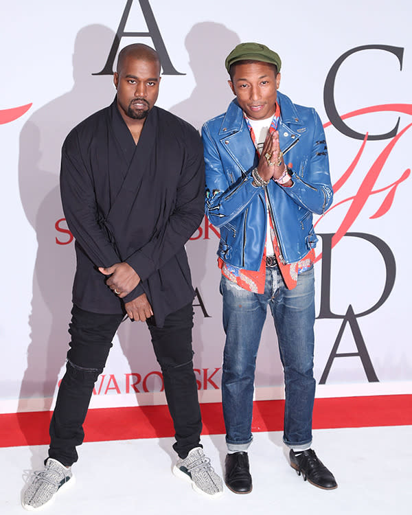 Kanye West and Pharrell Williams congratulating themselves for being rappers-turned-fashion moguls (Pharrell is taking home this year's CFDA "Fashion Icon" awards) in cool-guy jackets and shoes.