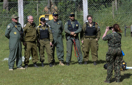 Israeli military personnel and Brazilian federal police officers pose for a picture, after a tailings dam owned by Brazilian mining company Vale SA collapsed, in Brumadinho, Brazil January 28, 2019. REUTERS/Washington Alves