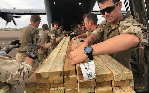 UK Aid building materials being unloaded from a Royal Canadian Air Force Hercules aircraft on Grand Turk, to replenish British troops supplies ahead of Hurricane Maria's imminent arrival - Credit: Georgina Stubbs/PA Wire