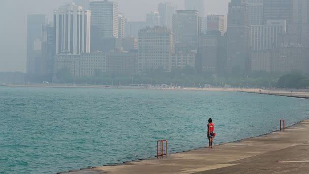 PHOTO: A lifeguard stands watch along the lakefront as wildfire smoke clouds the skyline on June 28, 2023 in Chicago. (Scott Olson/Getty Images)