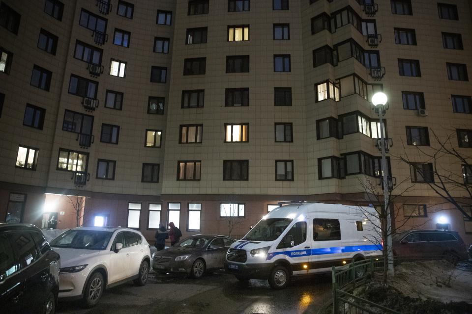 A Russian police van is parked at the apartment building of jailed opposition leader Alexei Navalny in Moscow, Russia, Wednesday, Jan. 27, 2021. Russian police are searching the apartment of jailed opposition leader Alexei Navalny, another apartment where his wife is living and two offices of his organization. (AP Photo/Pavel Golovkin)