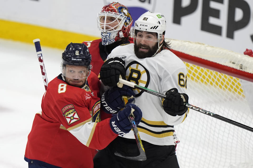 Boston Bruins left wing Pat Maroon (61) Florida Panthers right wing Kyle Okposo (8) and goaltender Sergei Bobrovsky, rear, battle for position in front of the net during the first period of Game 5 of the second-round series of the Stanley Cup Playoffs, Tuesday, May 14, 2024, in Sunrise, Fla. (AP Photo/Wilfredo Lee)