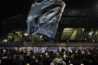 People gather outside the San Paolo Stadium to pay their homage to soccer legend Diego Maradona, in Naples, Italy, Wednesday, Nov. 25, 2020. Diego Maradona has died. The Argentine soccer great was among the best players ever and who led his country to the 1986 World Cup title before later struggling with cocaine use and obesity. He was 60. (Fabio Sasso/LaPresse via AP)