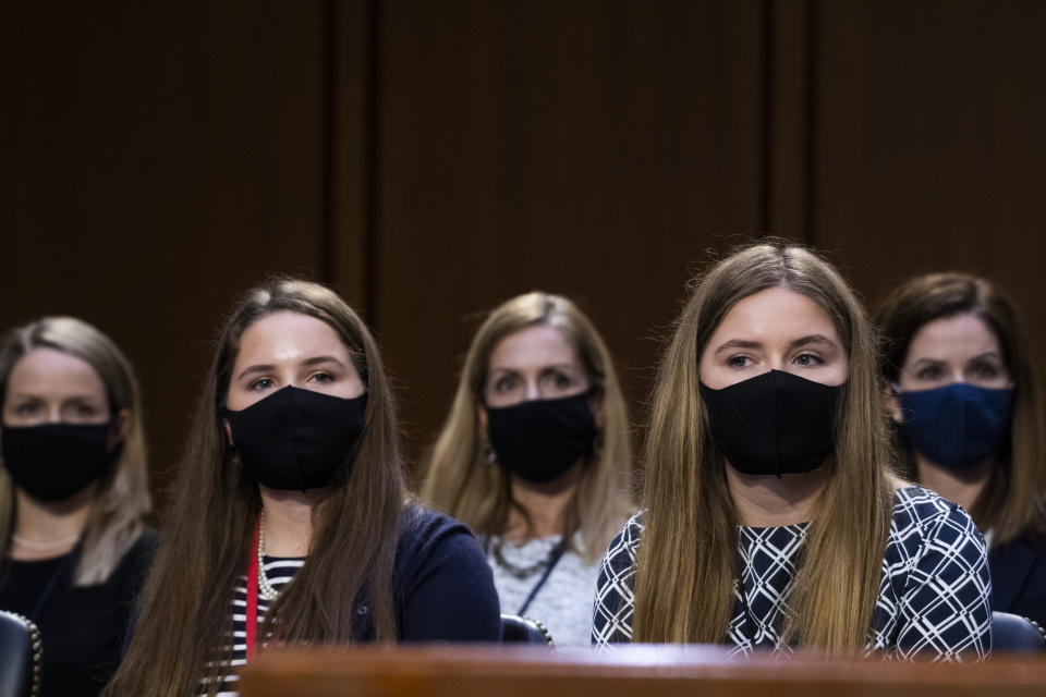 Family members of Supreme Court nominee Amy Coney Barrett listen during her confirmation hearing before the Senate Judiciary Committee on Capitol Hill in Washington, Tuesday, Oct. 13, 2020. (Tom Williams/Pool via AP)