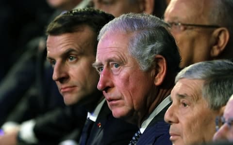 Prince Charles sit next to French President Emmanuel Macron - Credit: ABIR SULTAN