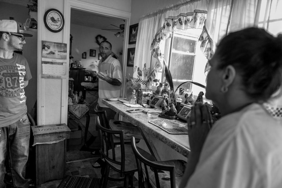 <p>Gene Robinson, middle, talks to his step-son Larry Fugate, left, and far right, mom Terri Fugate at their home in Middletown, Ohio. Both men are recovering heroin addicts.<br> (Photograph by Mary F. Calvert for Yahoo News) </p>