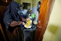 Mona Muhammad prepares food at her house in Sanaa