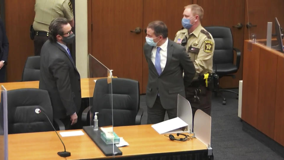 FILE - In this April 20, 2021 file image from video, former Minneapolis police Officer Derek Chauvin, center, is taken into custody as his attorney, Eric Nelson, left, looks on, after the verdicts were read at Chauvin's trial for the 2020 death of George Floyd, at the Hennepin County Courthouse in Minneapolis, Minn. Chauvin, convicted of murder in the death of Floyd is scheduled to make his initial appearance via videoconference, Tuesday, June 1, 2021, on federal charges that he violated Floyd's civil rights when he placed his knee on the Black man's neck, pinning him to the street. (Court TV via AP, Pool, File)