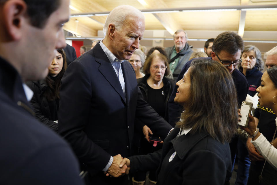 Democratic presidential candidate former Vice President Joe Biden talks with audience members during a bus tour stop at Water's Edge Nature Center, Monday, Dec. 2, 2019, in Algona, Iowa. (AP Photo/Charlie Neibergall)