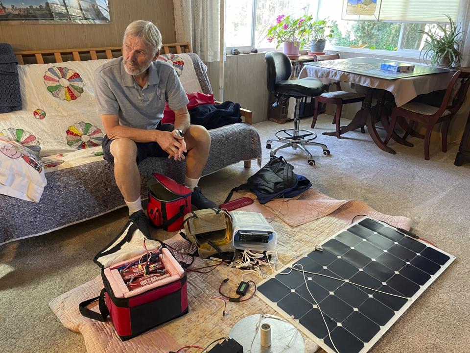 Balloon pilot Peter Cuneo looks over his gear during an interview Sept. 21, 2023, in Albuquerque, N.M. It's been 15 years since the world's elite gas balloon pilots have gathered in the United States for the Coupe Gordon Bennett, a long-distance race whose roots stretch back more than a century. Cuneo and his wife, Barbara Fricke, will participate in the 2023 Gordon Bennett competition. (AP Photo/Susan Montoya Bryan)