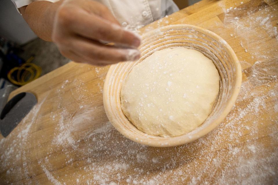 Chrissy Jensen sprinkles gluten free dough with flour at The Dotted Lime Bakery in Columbia, Tenn. on Aug. 30, 2022