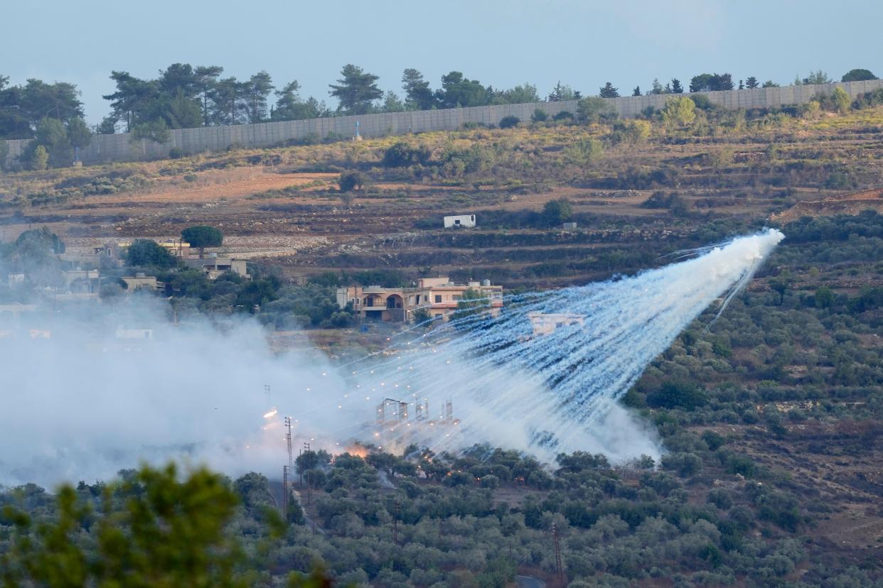 A shell from Israeli artillery exploded over a house in al-Bustan, a Lebanese border village, on Sunday (AP Photo/Hussein Malla)