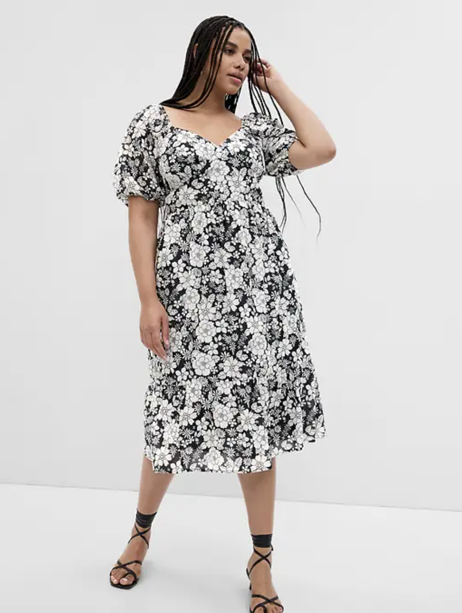 plus size model wearing black sandals and black and white Puff Sleeve Metallic Floral Midi Dress (photo via Gap)
