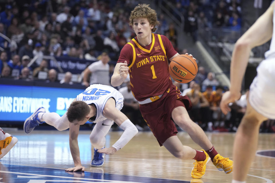 Iowa State guard Jackson Paveletzke (1) drives the ball past BYU guard Spencer Johnson (20) during the first half of an NCAA college basketball game Tuesday, Jan. 16, 2024, in Provo, Utah. (AP Photo/George Frey)