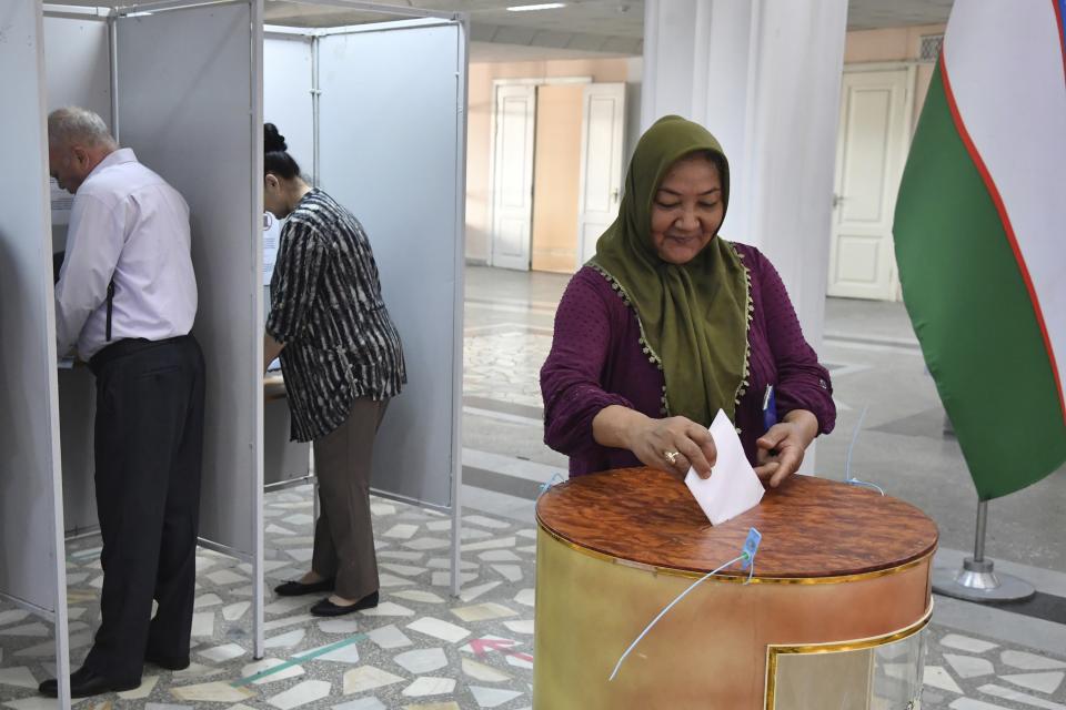 A woman casts her ballot at a polling station during a referendum in Tashkent, Uzbekistan, Sunday, April 30, 2023. Voters in Uzbekistan are casting ballots in a referendum on a revised constitution that promises human rights reforms. But the reforms being voted on Sunday also would allow the country's president to stay in office until 2040. (AP Photo)