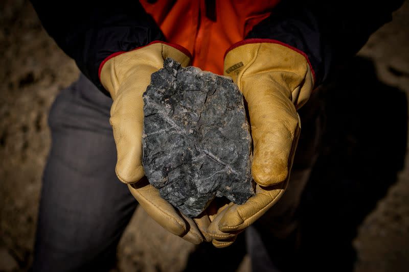 FILE PHOTO: A person holds a rock sample at Anglo American's Los Bronces copper mine in Chile