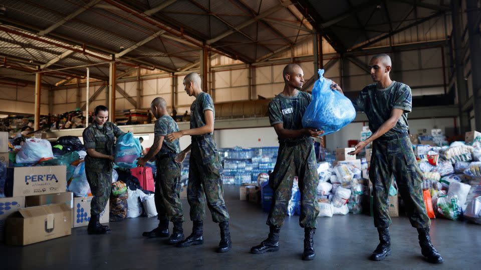 Brazilian Air Force Soldiers prepare donations for flood victims at the Brasilia Air Force Base. - Adriano Machado/Reuters