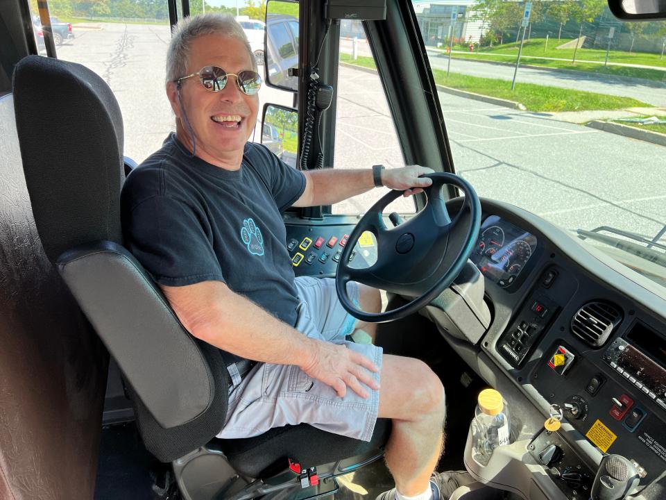 Rob Robenstein sits behind the wheel of school bus number three, the electric school bus he drives for the South Burlington School District. The driver of seven years enjoys the quieter ride with fewer emissions and celebrated one year and 9,000 miles driving electric for the district on Aug. 28, 2023.