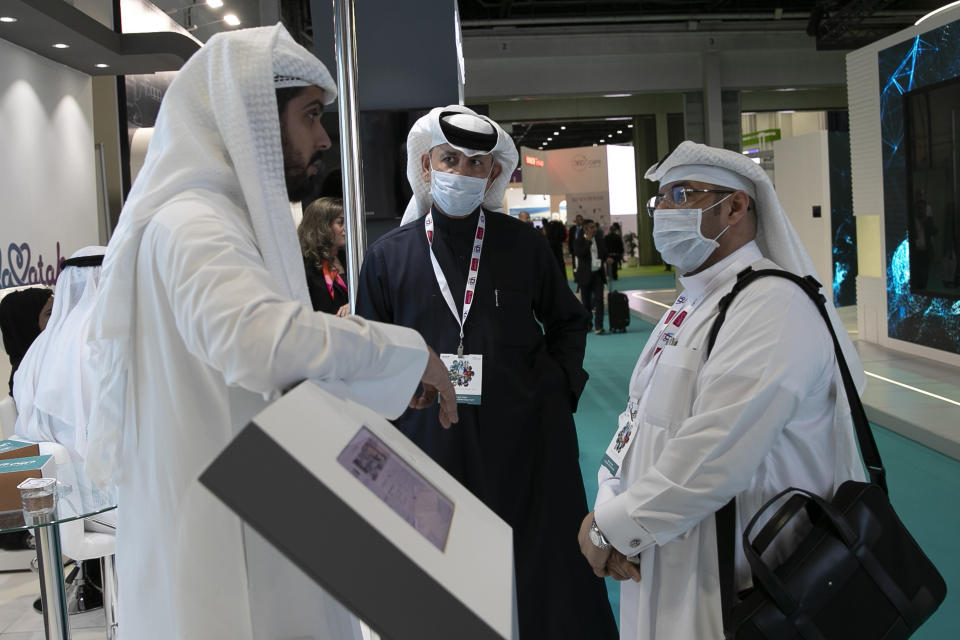 Visitors and exhibitors wear masks at the Arab Health Exhibition in Dubai, United Arab Emirates, Wednesday, Jan. 29, 2020. The United Arab Emirates on Wednesday confirmed the first cases in the Mideast of the new Chinese virus that causes flu-like symptoms, saying doctors now were treating a family that had just come from a city at the epicenter of the outbreak. (AP Photo/Kamran Jebreili)