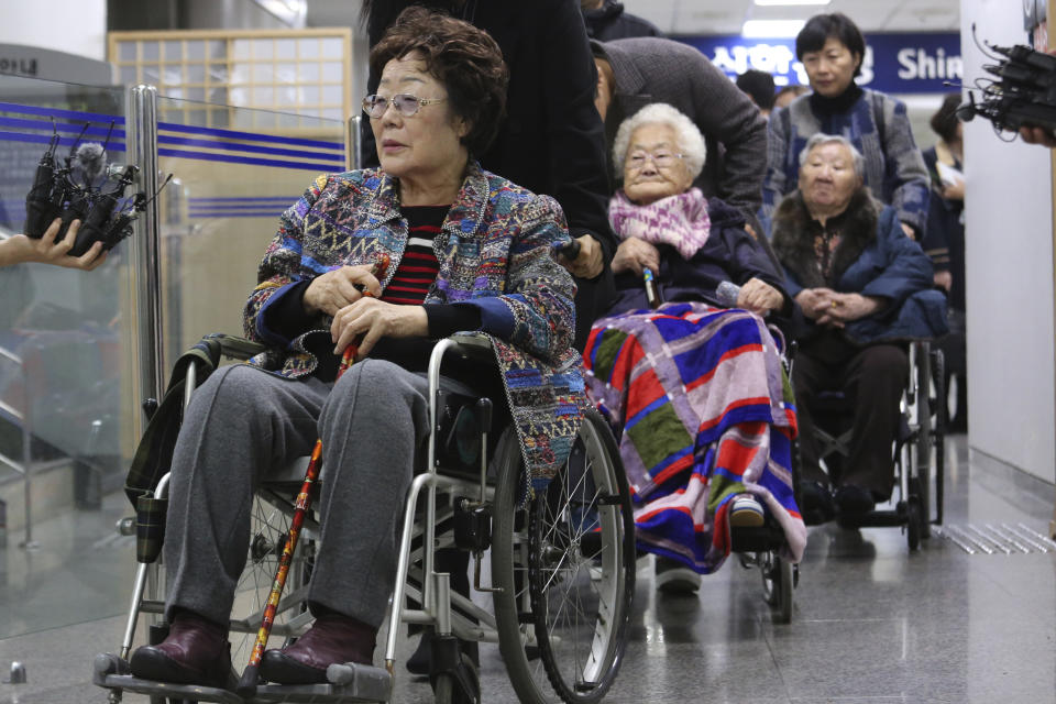 Former South Korean comfort women, Lee Yong-soo, left, Lee Ok-seon and Gil Won-ok, right, leave the Seoul Central District Court in Seoul, South Korea, Wednesday, Nov. 13, 2019. A Seoul court on Wednesday began hearing a long-awaited civil case filed against the Japanese government by South Korean women who were forced to work in Japan's World War II military brothels. (AP Photo/Ahn Young-joon)