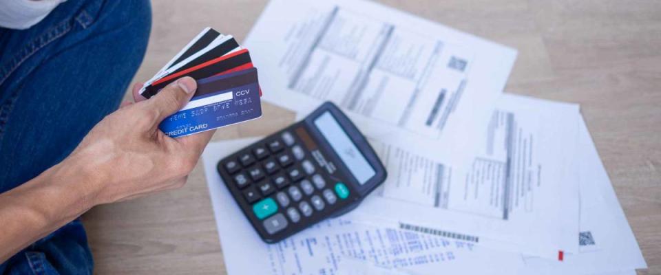 Business men sitting stressed out with home expenses and monthly credit card debt.