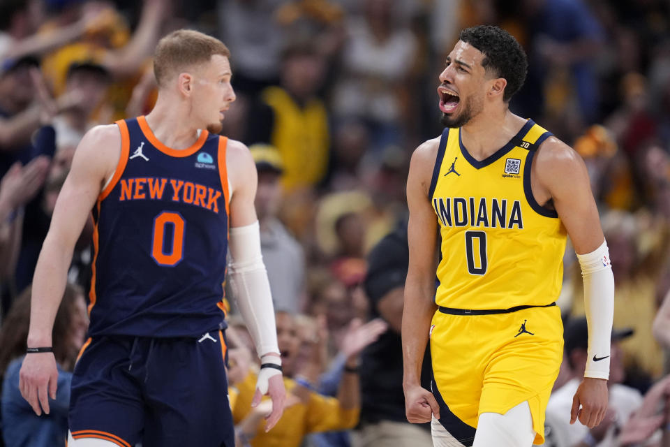 Indiana Pacers guard Tyrese Haliburton celebrates in front of New York Knicks guard Donte DiVincenzo, left, after making a three-point basket during the first half of Game 4 in an NBA basketball second-round playoff series, Sunday, May 12, 2024, in Indianapolis. (AP Photo/Michael Conroy)