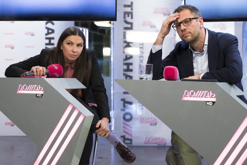 FILE - In this Tuesday, Feb. 4, 2014 file photo, the owner of Dozhd TV (Rain TV) station, Alexander Vinokurov, right, and Dozhd's director Nataliya Sindeyeva listen to a question during a press conference at the channel's headquarters in Moscow. The independent television station Dozhd, or TV Rain, came under attack after asking viewers in January whether the Soviet Union should have surrendered Leningrad, now St. Petersburg, to save the lives of the 1 million people who died during the nearly 900-day Nazi siege of the city during the war. The station quickly pulled the poll and apologized, but President Vladimir Putin’s spokesman said the station had crossed a “red line.” Russian cable operators lined up to drop Dozhd from their packages and prosecutors opened an investigation. (AP Photo/Alexander Zemlianichenko, file)