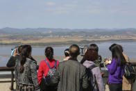 Visitors watch the North Korea side from the Unification Observation Post in Paju, South Korea, near the border with North Korea, Tuesday, Oct. 15, 2019. Amid swine fever scare that grips both Koreas, South Korea is deploying snipers, installing traps and flying drones along the rivals' tense border to kill wild boars that some experts say may have spread the animal disease from north to south. (AP Photo/Ahn Young-joon)