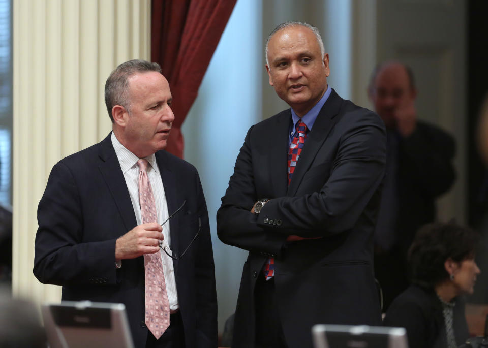 Senate President Pro Tem Darrell Steinberg, D-Sacramento, left, talks with Sen. Ed Hernandez, D-Covina at the Capitol in Sacramento, Calif., Monday, April 21, 2014. Hernandez proposed a constitutional amendment that would ask voters to again allow public colleges to use race and ethnicity when considering college applicants. The proposal stalled this year after backlash from Asian Americans.(AP Photo/Rich Pedroncelli)