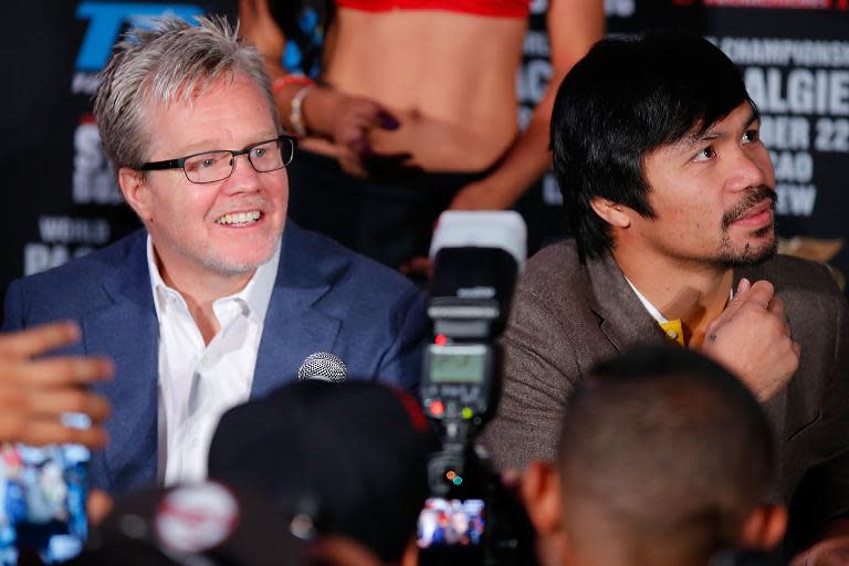 Freddy Roach (R) says Manny Pacquiao could beat Mayweather but cautions it will take a near-perfect performance and supreme concentration from 'Pacman'