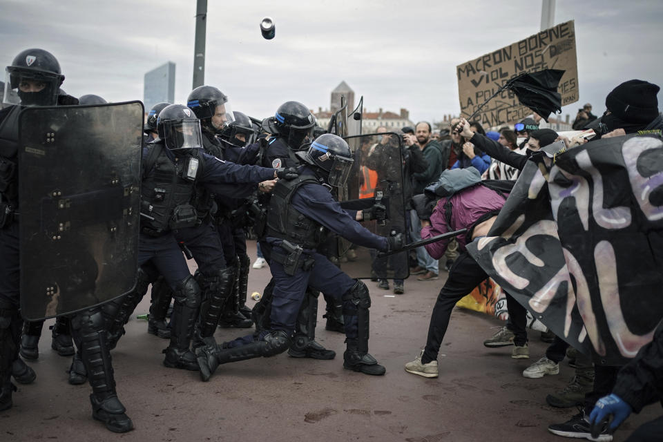 FILE - Protesters clash with police officers during a demonstration in Lyon, central France, on March 23, 2023. French authorities see the police as protectors ensuring that citizens can peacefully protest President Emmanuel Macron’s contentious retirement age increase. But to human rights advocates and demonstrators who were clubbed or tear-gassed, officers have overstepped their mission. (AP Photo/Laurent Cipriani, File)