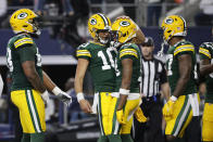 Green Bay Packers quarterback Jordan Love (10) celebrates with wide receiver Dontayvion Wicks (13) after they combined for a touchdown pass and catch during the first half of an NFL football game against the Dallas Cowboys, Sunday, Jan. 14, 2024, in Arlington, Texas. (AP Photo/Michael Ainsworth)