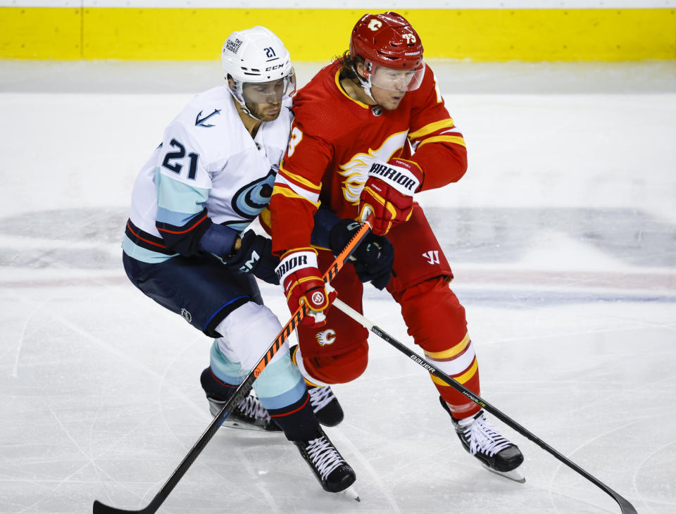 Seattle Kraken forward Alexander Wennberg, left, checks Calgary Flames forward Tyler Toffoli during the third period of an NHL hockey game, Tuesday, Nov. 1, 2022 in Calgary, Alberta. (Jeff McIntosh/The Canadian Press via AP)