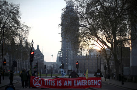 Climate change activists block a road during the Extinction Rebellion protest at Parliament Square in London, Britain April 16, 2019. REUTERS/Hannah McKay