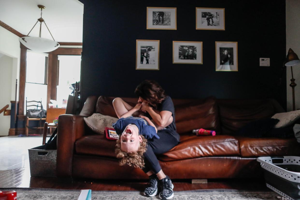 Erin Kiernan and Michael Francis Kiernan play on the couch together on Friday, June 9.