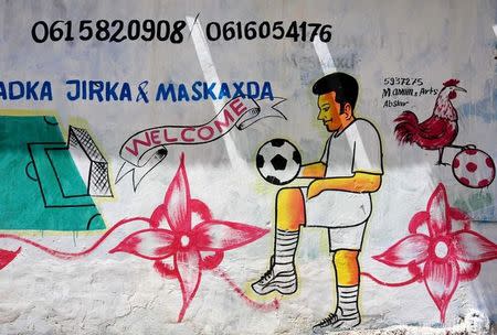 A mural depicting a soccer player is seen on a wall of a stadium in Hodan district of Mogadishu, Somalia, June 13, 2017. REUTERS/Feisal Omar SEARCH "OMAR SHOPS" FOR THIS STORY. SEARCH "WIDER IMAGE" FOR ALL STORIES.