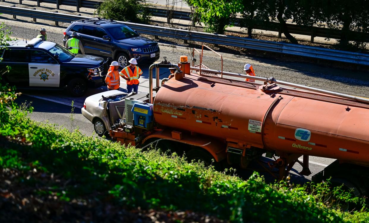 Emergency crews work a collision that killed a woman Tuesday, June 28 on highway 198 just before 4 p.m. The Toyota Corolla she was driving collided with the rear of a parked water truck operated by Cal Trans.