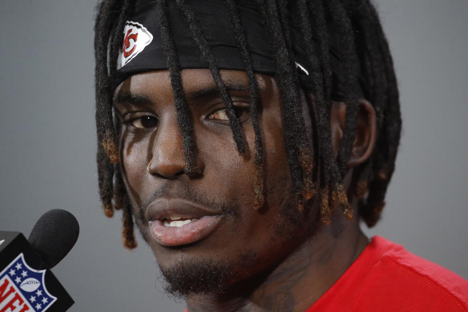 FILE - In this Jan. 18, 2019, file photo, Kansas City Chiefs wide receiver Tyreek Hill talks to the media after a workout in Kansas City, Mo. The Kansas City Chiefs have made a habit of inciting controversy during the NFL draft in the Andy Reid era by acquiring players that have a history of off-the-field issues. The team took a chance on cornerback Marcus Peters, who was traded away after getting into trouble with coaches. It drafted running back Kareem Hunt, then quickly cut him when he kicked a woman in a hotel hallway. And it picked wide receiver Tyreek Hill, who is currently dealing with a domestic violence case that centers on the 3-year-old child he shares with his fiance. (AP Photo/Charlie Riedel, File)