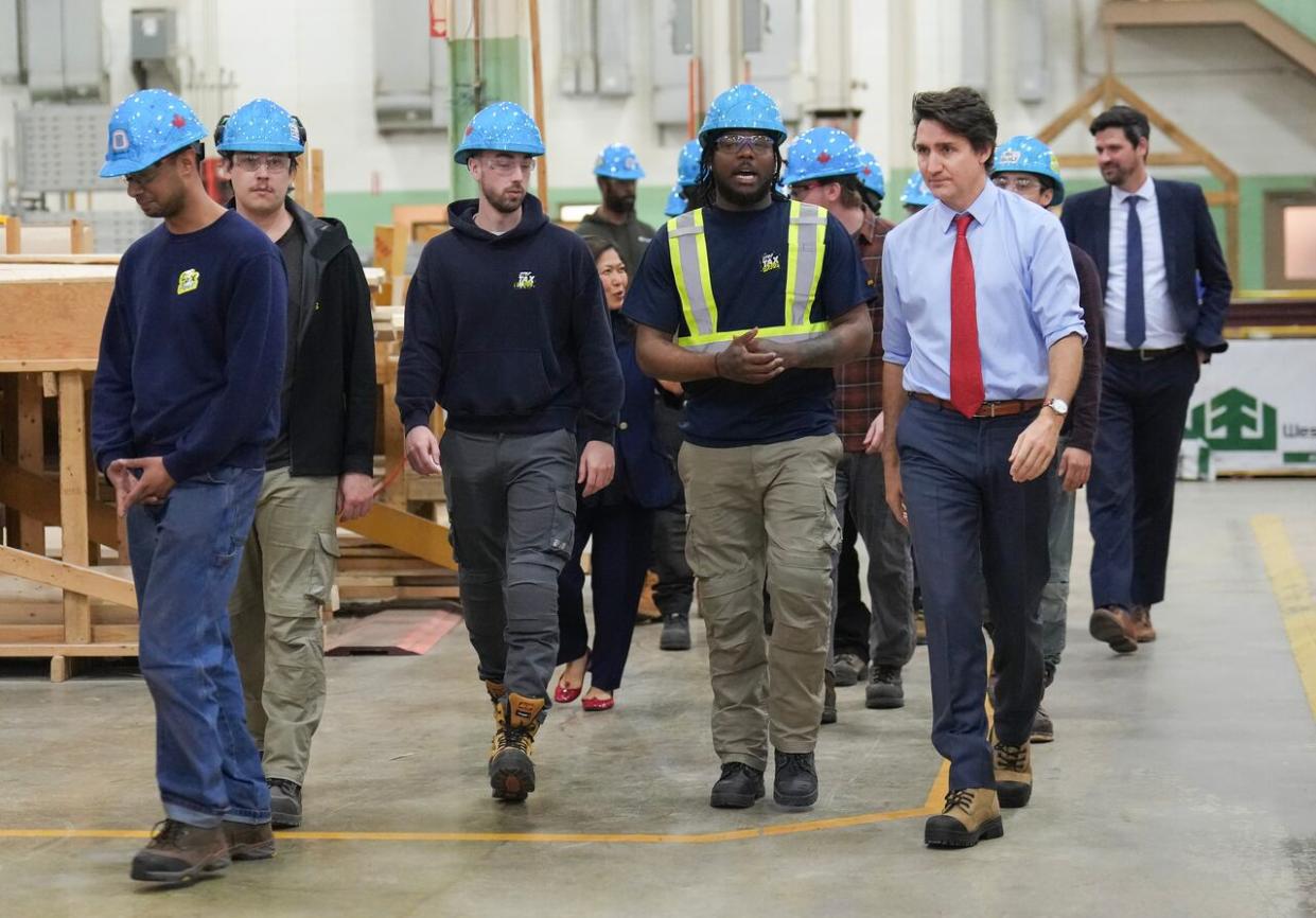 Prime Minister Justin Trudeau, right, meets with carpenters before speaking about new housing solutions at the CCAT training centre in Woodbridge, Ont., on Friday, April 12, 2024. (Nathan Denette/The Canadian Press - image credit)