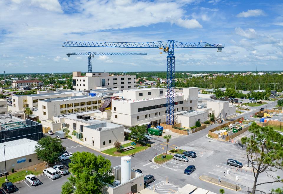 Construction towers loom over Gulf Coast Regional Medical Center on June 28 during the hospital's $62 million tower project.