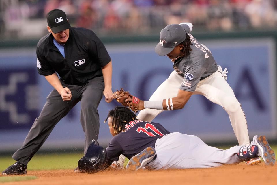 Cleveland Guardians' Jose Ramirez (11) is tagged out at second base by Washington Nationals shortstop CJ Abrams, right, during the third inning of a baseball game in Washington, Friday, April 14, 2023. (AP Photo/Manuel Balce Ceneta)