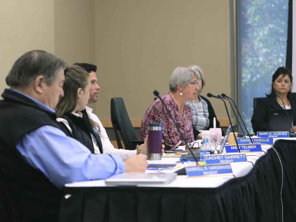 Regent Karen Perdue, center, speaks at an emergency meeting of the University of Alaska Board of Regents on Monday, July 22, 2019, in Anchorage, Alaska. Regents voted 10-1 to declare a financial exigency, allowing administrators to expedite layoffs of tenured faculty in the face of severe budget issues. (AP Photo/Dan Joling)